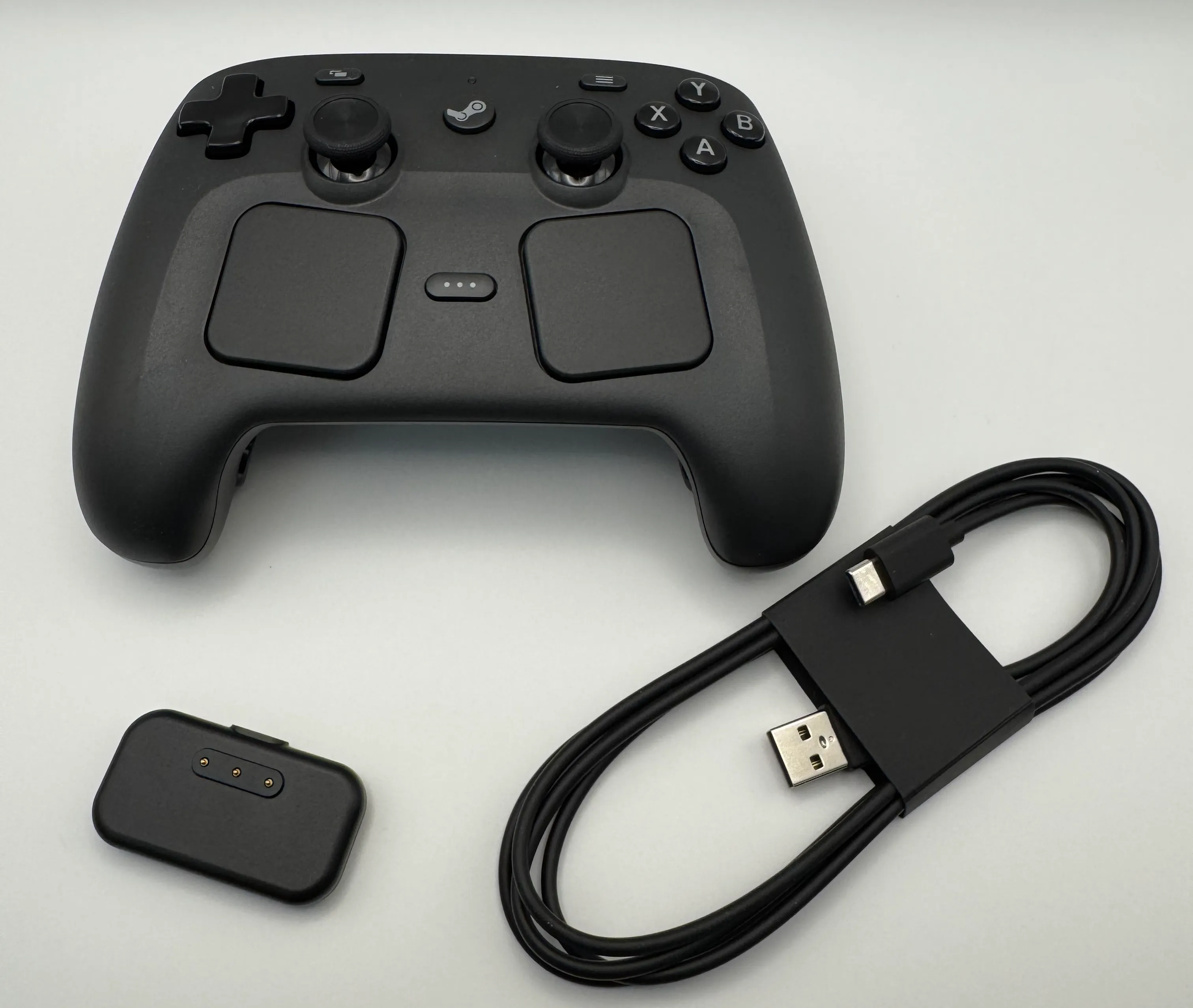 Controller, USB cable, and charging puck out of the box