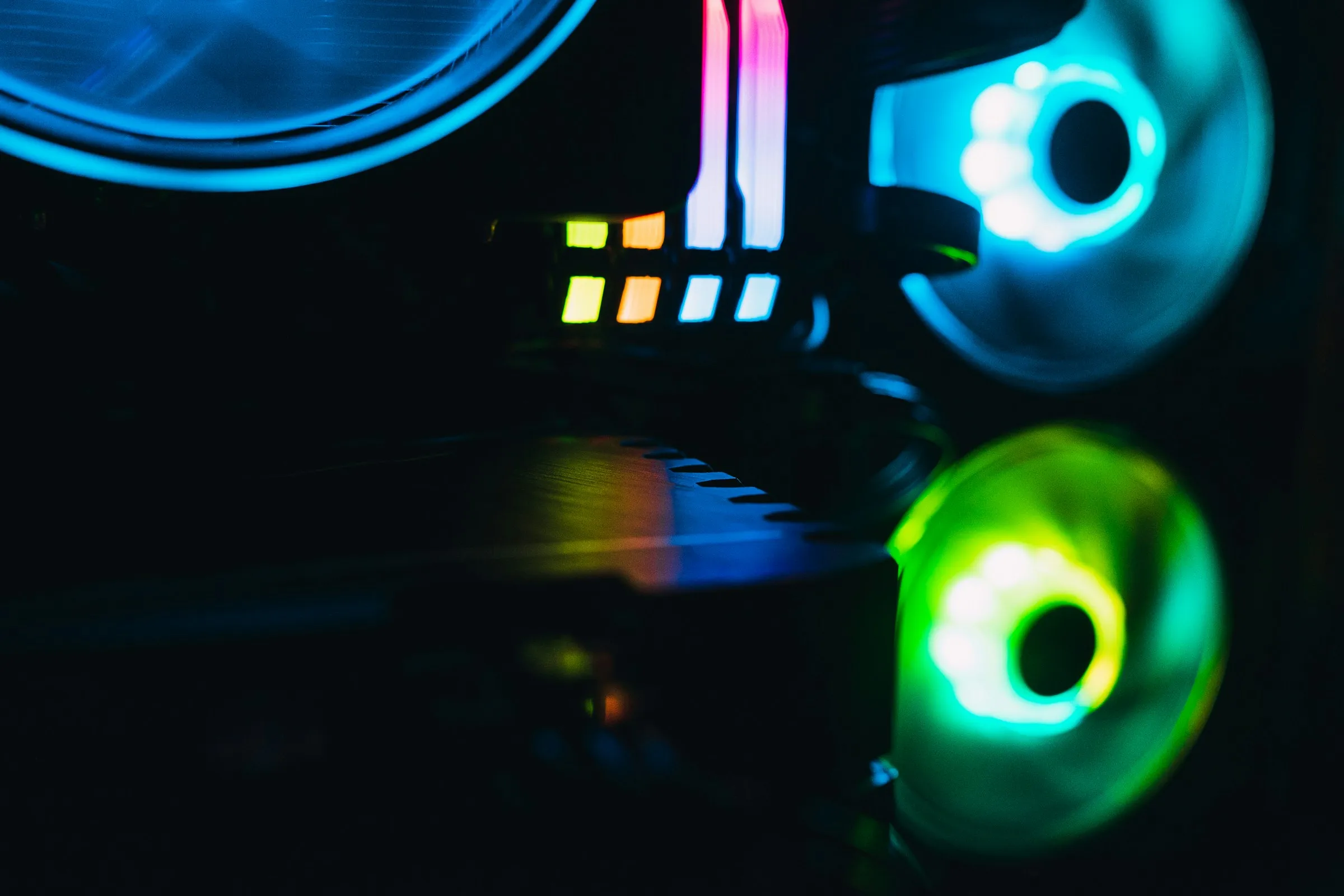 Darkened interior shot of a computer with RGB fans and RAM sticks